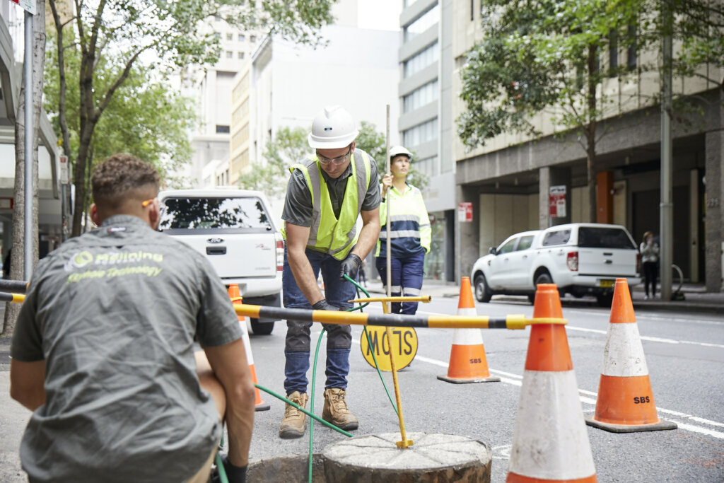 Workers repairing roadside sewage drain