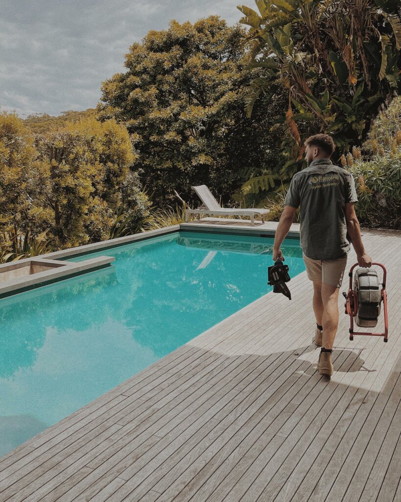 Man walking around pool with pipe relining gear
