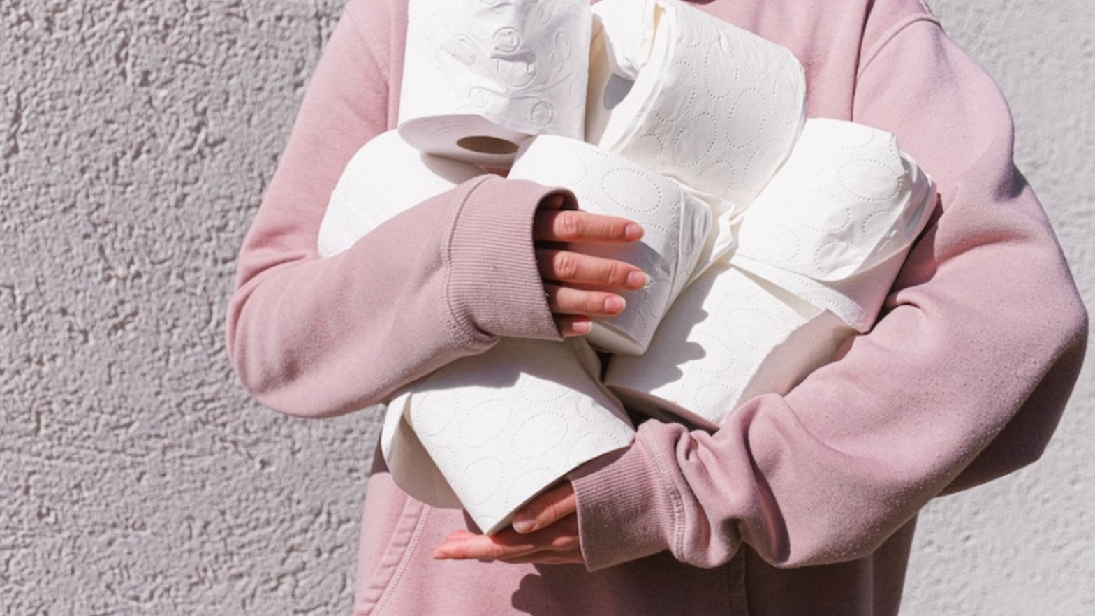 Someone holding a pile of toilet paper