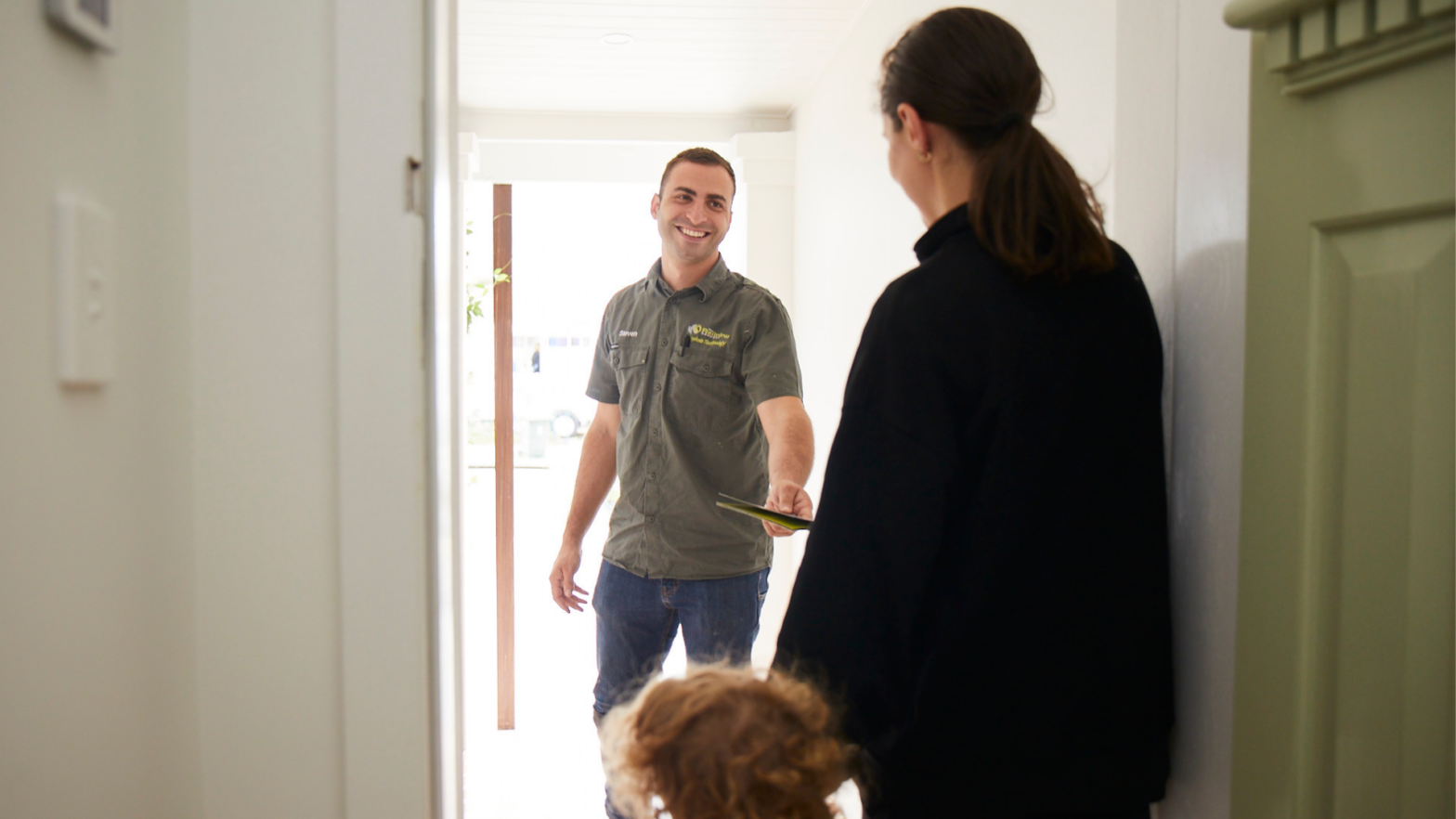 Employee greeting women and child